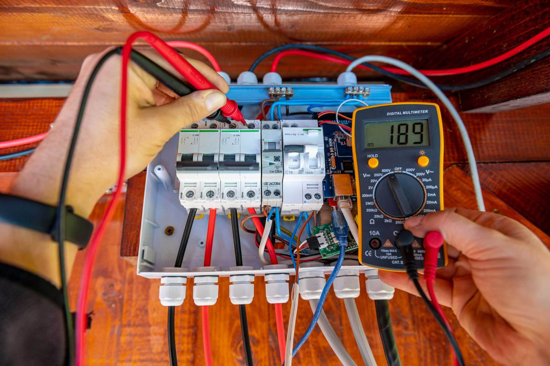 Electrician testing and energizing commercial electrical systems